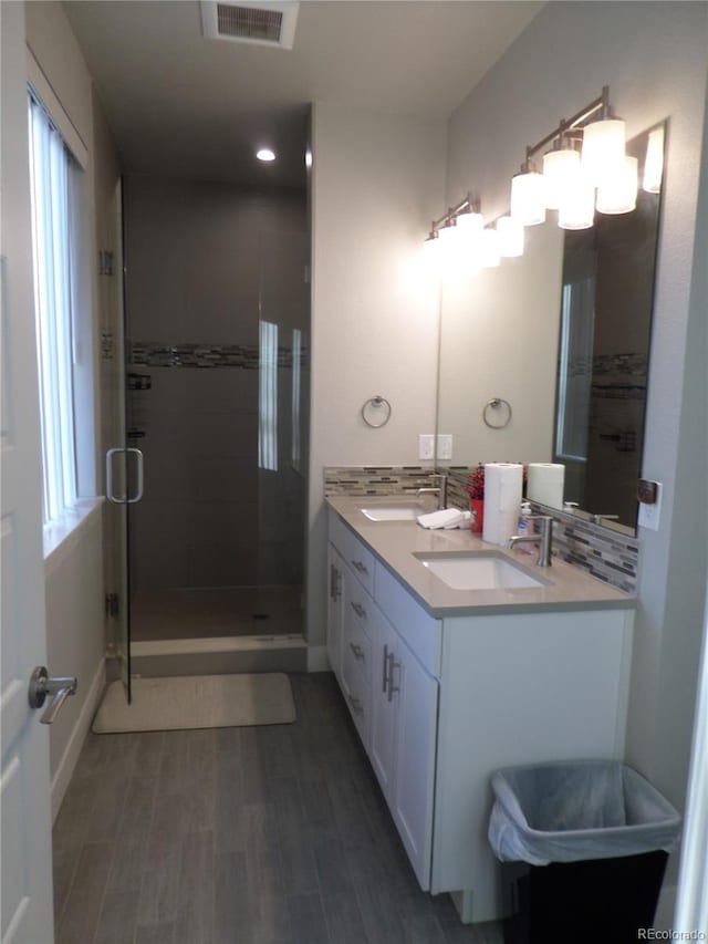 bathroom featuring vanity, wood-type flooring, and walk in shower