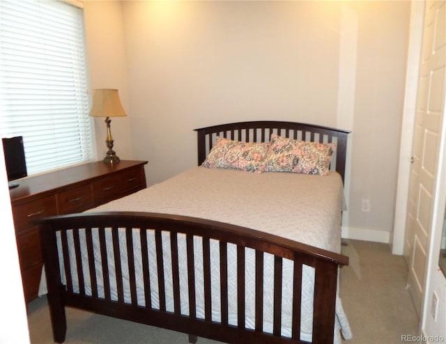 bedroom featuring light colored carpet