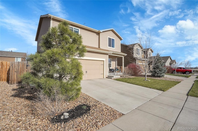 view of front of home with a garage, concrete driveway, and fence