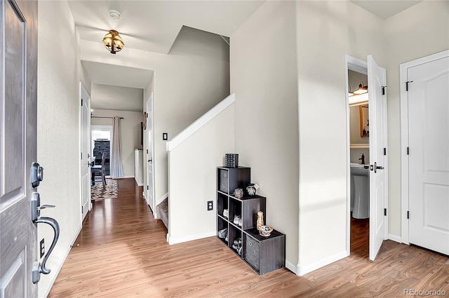 entryway with light wood finished floors and baseboards