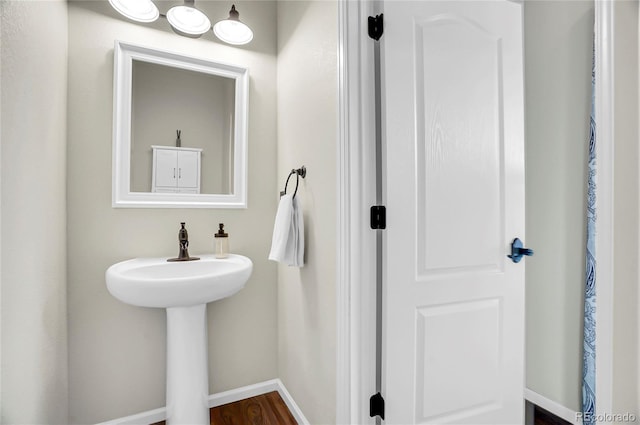 bathroom featuring wood finished floors and baseboards