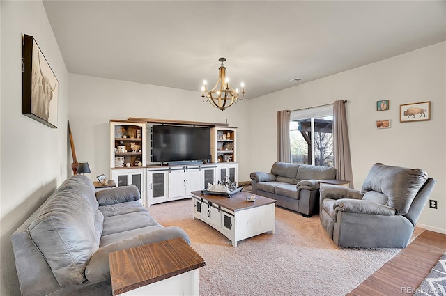 living area with a chandelier, visible vents, and light wood-style flooring