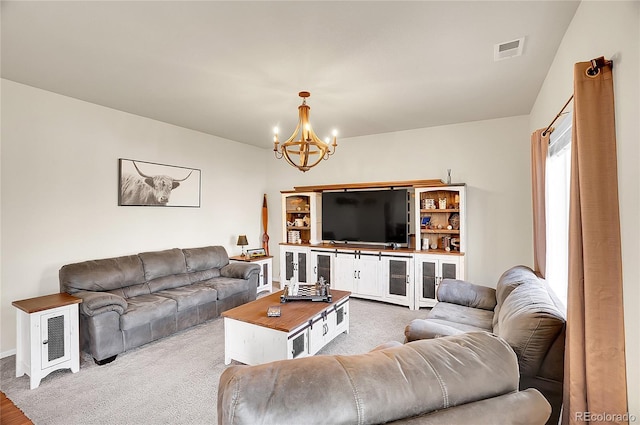 living room featuring baseboards, visible vents, and a notable chandelier