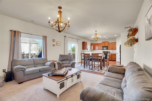 living room with recessed lighting, visible vents, and a notable chandelier