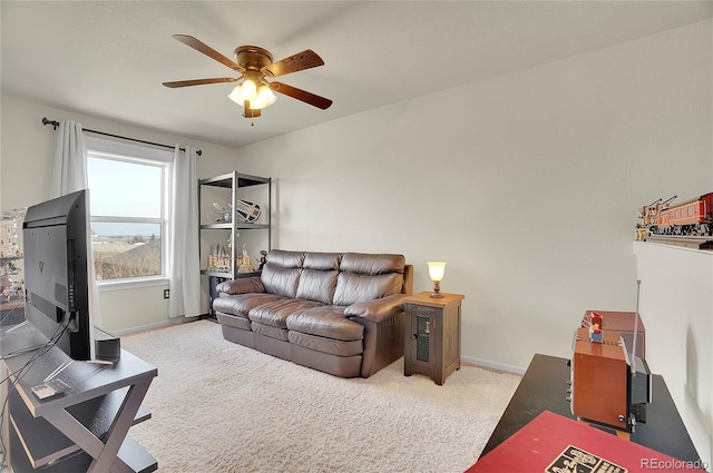 living room with ceiling fan, carpet floors, and baseboards