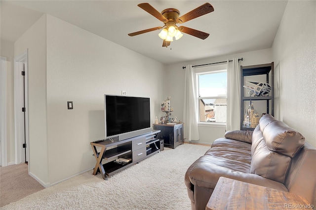 living room with carpet flooring, baseboards, and ceiling fan