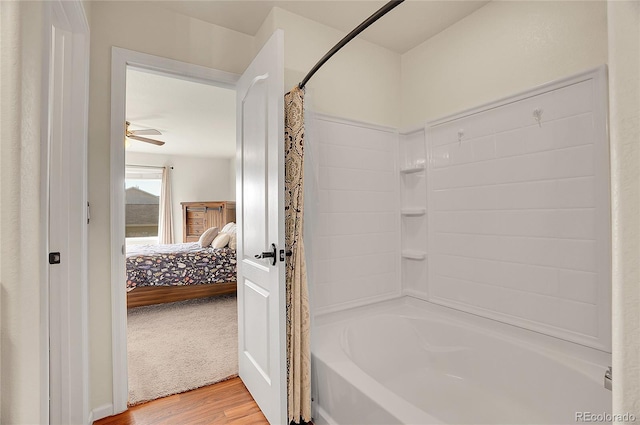ensuite bathroom with wood finished floors, ensuite bath, and shower / tub combo