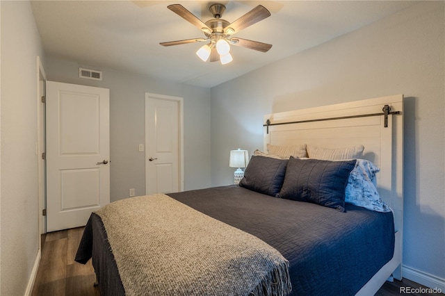 bedroom featuring ceiling fan and dark hardwood / wood-style floors