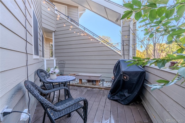 wooden deck with a grill