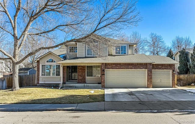 traditional-style home featuring a garage, brick siding, fence, driveway, and a front yard