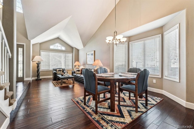 dining room featuring high vaulted ceiling, dark wood finished floors, baseboards, and an inviting chandelier