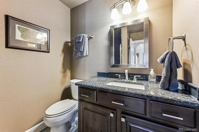 bathroom with toilet and vanity