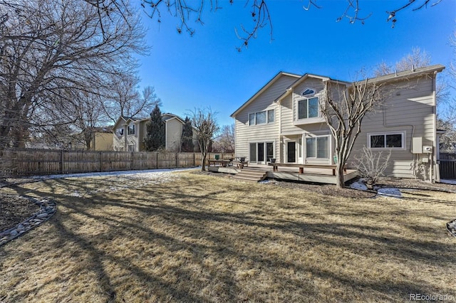 back of property featuring fence private yard, a lawn, and a deck