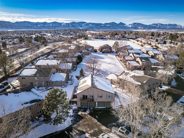 snowy aerial view with a mountain view