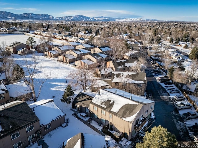 snowy aerial view featuring a mountain view