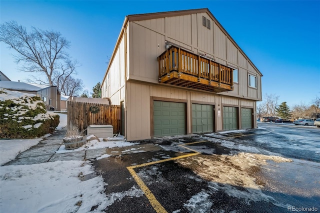 exterior space with a balcony and a garage