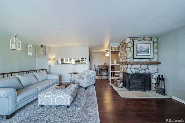 living room with ceiling fan, hardwood / wood-style floors, and a fireplace