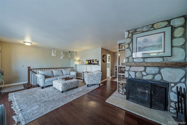 living room featuring a fireplace and dark hardwood / wood-style floors