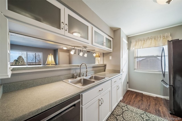 kitchen with sink, white cabinetry, a wealth of natural light, and appliances with stainless steel finishes