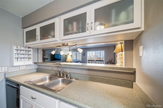 kitchen with sink, dishwasher, and white cabinets