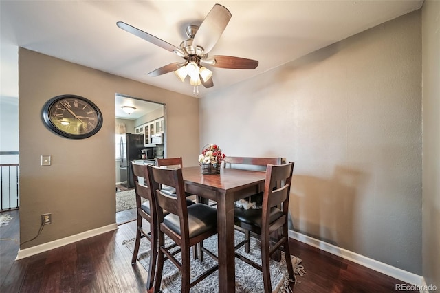 dining area featuring dark wood-type flooring and ceiling fan