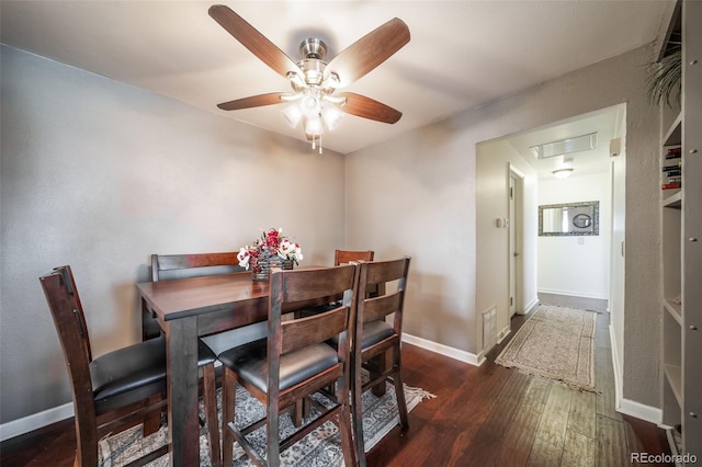 dining room with ceiling fan and dark wood-type flooring