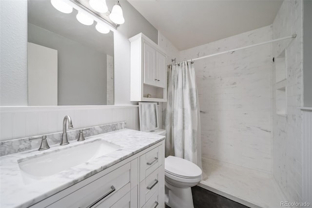 bathroom with vanity, toilet, and walk in shower