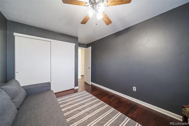 bedroom with ceiling fan, a closet, and dark hardwood / wood-style flooring