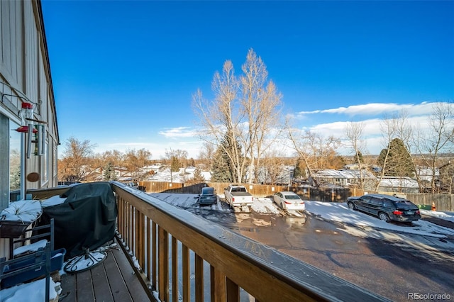 view of snow covered back of property