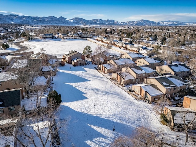 snowy aerial view with a mountain view