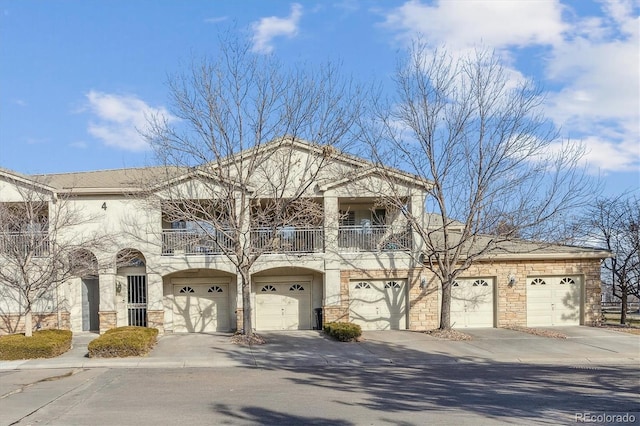 view of front of home with a garage and a balcony