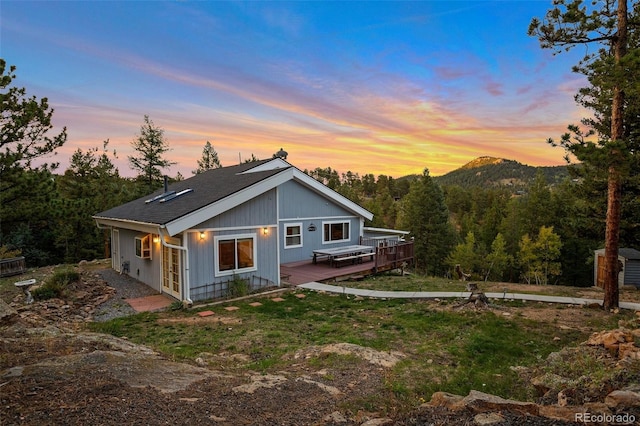 11348 Ranch Elsie Rd, Golden, CO 80403 - back of property at dusk featuring a wooden deck