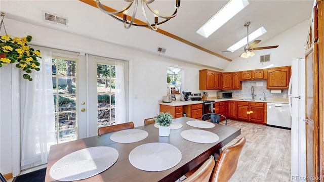 11348 Ranch Elsie Rd, Golden, CO 80403 - dining area featuring light wood finished floors, visible vents, a chandelier, and a skylight