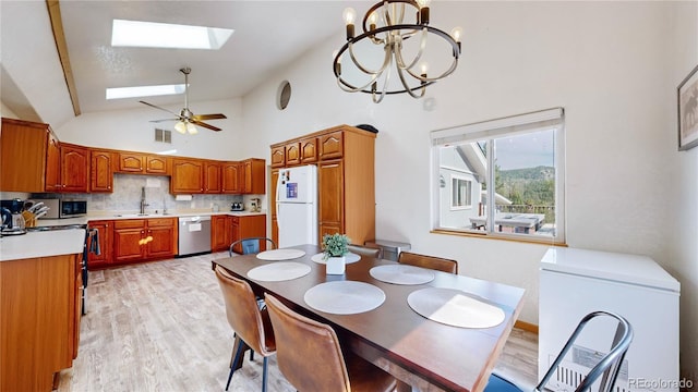 11348 Ranch Elsie Rd, Golden, CO 80403 - dining area featuring light wood-style flooring, visible vents, a skylight, and ceiling fan with notable chandelier