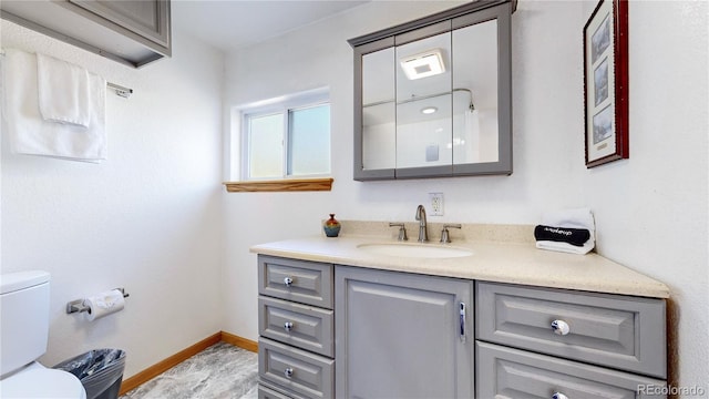 11348 Ranch Elsie Rd, Golden, CO 80403 - bathroom featuring toilet, baseboards, and vanity