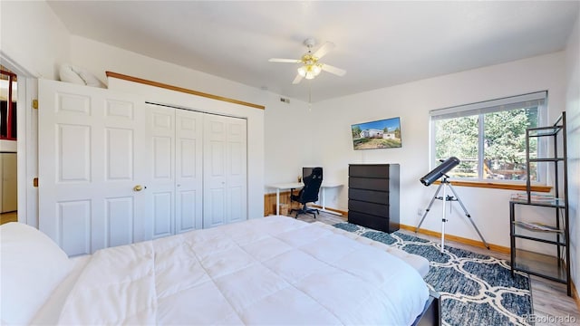 11348 Ranch Elsie Rd, Golden, CO 80403 - bedroom with a closet, wood finished floors, visible vents, a ceiling fan, and baseboards
