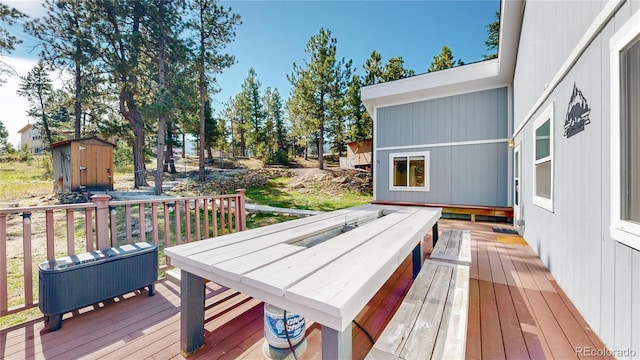 11348 Ranch Elsie Rd, Golden, CO 80403 - wooden deck with a storage shed and an outbuilding