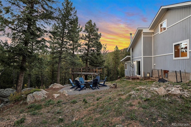 11348 Ranch Elsie Rd, Golden, CO 80403 - yard at dusk with an outdoor fire pit