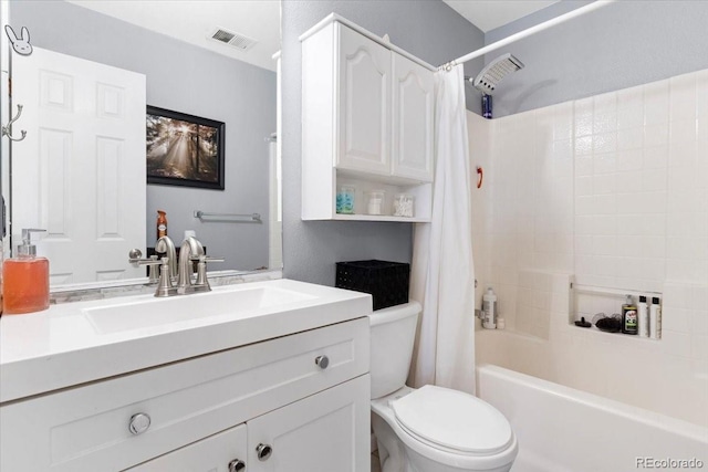 full bathroom with vanity, shower / tub combo, and toilet