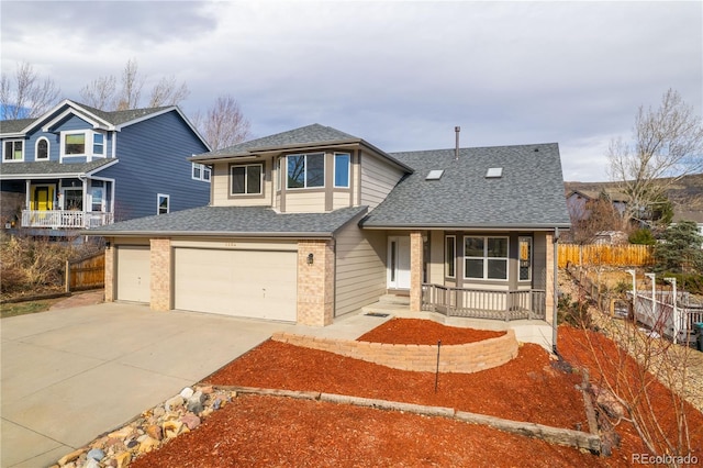 view of property with covered porch and a garage