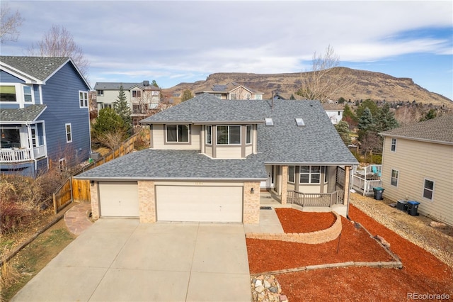 view of front of property featuring a mountain view, a garage, and cooling unit