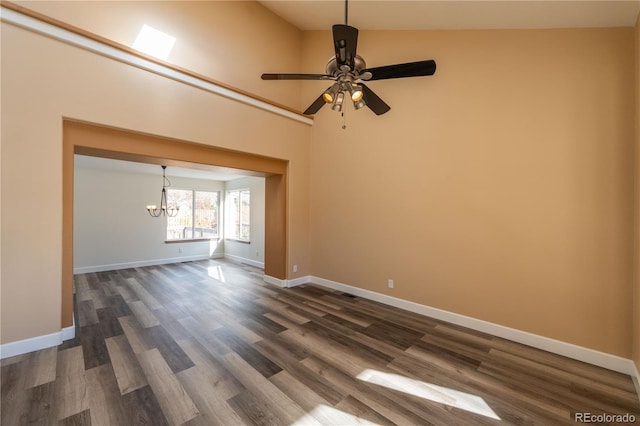 interior space with ceiling fan with notable chandelier, dark hardwood / wood-style floors, and high vaulted ceiling