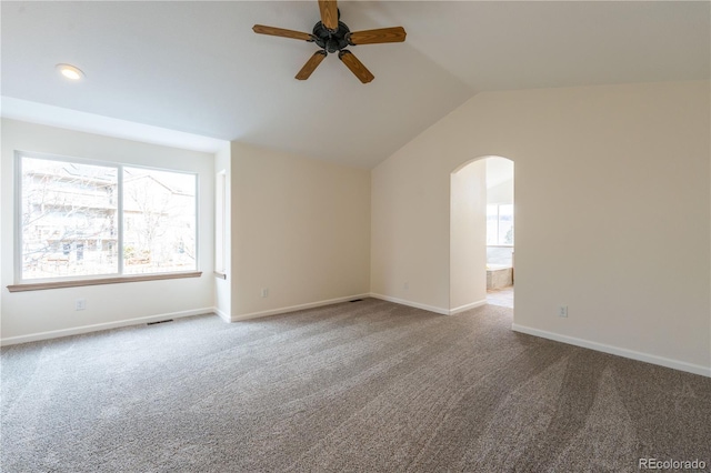 spare room featuring carpet flooring, vaulted ceiling, and ceiling fan