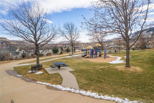 view of property's community featuring a playground and a yard