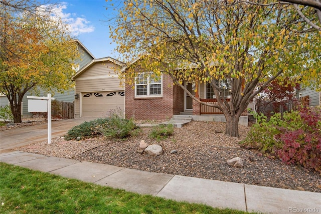 view of property hidden behind natural elements with a garage