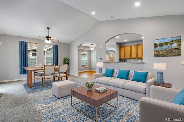 carpeted living room featuring ceiling fan, lofted ceiling, and a wealth of natural light