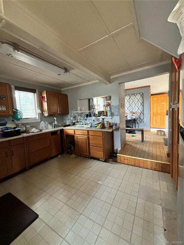 kitchen featuring light tile patterned flooring, ornamental molding, and kitchen peninsula