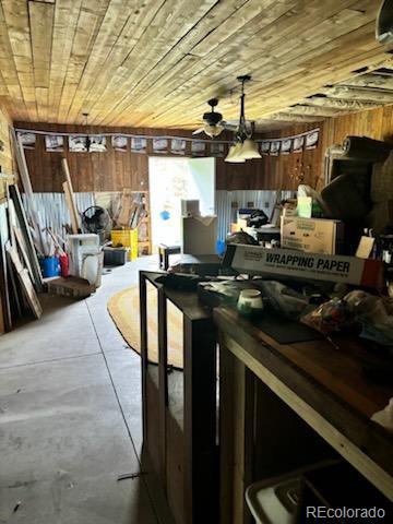 interior space featuring ceiling fan and concrete flooring