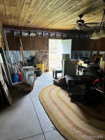 interior space featuring ceiling fan and wooden ceiling