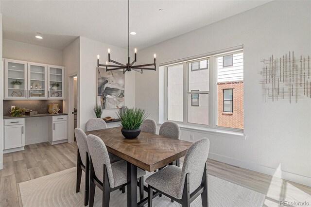 dining room featuring a notable chandelier and light hardwood / wood-style floors